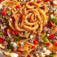 New! Steakhouse Nachos · Our warm tortilla chips topped with queso and seasoned ground beef, and layered with shredde...