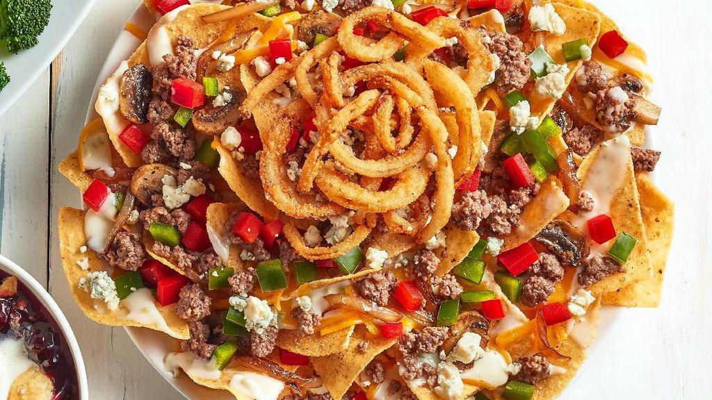 New! Steakhouse Nachos · Our warm tortilla chips topped with queso and seasoned ground beef, and layered with shredded cheddar, Cajun mushroom and onions, diced red and green peppers. Topped with bleu cheese crumbles and crispy fried onions.