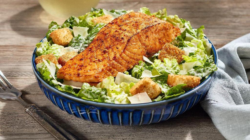 Salmon Caesar* · Our 6-oz. perfectly grilled salmon sprinkled with our special herb seasoning, served on a bed of romaine lettuce that’s been tossed in our creamy Caesar dressing, topped with croutons and parmesan cheese.