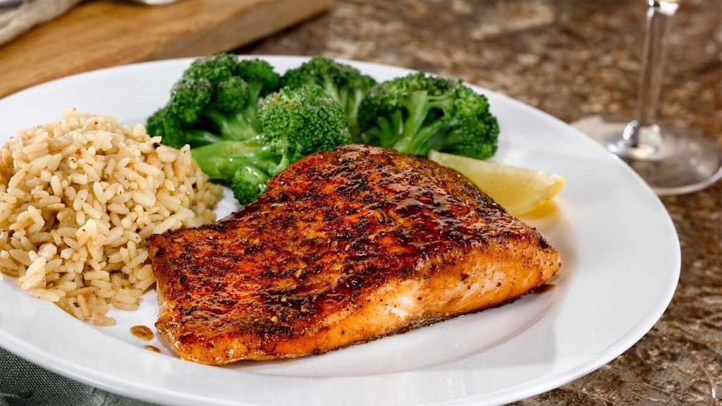 Grilled Atlantic Salmon* · Hand-cut, herb-seasoned and served with two sides. Also available Blackened, Bourbon-Glazed or Chipotle.