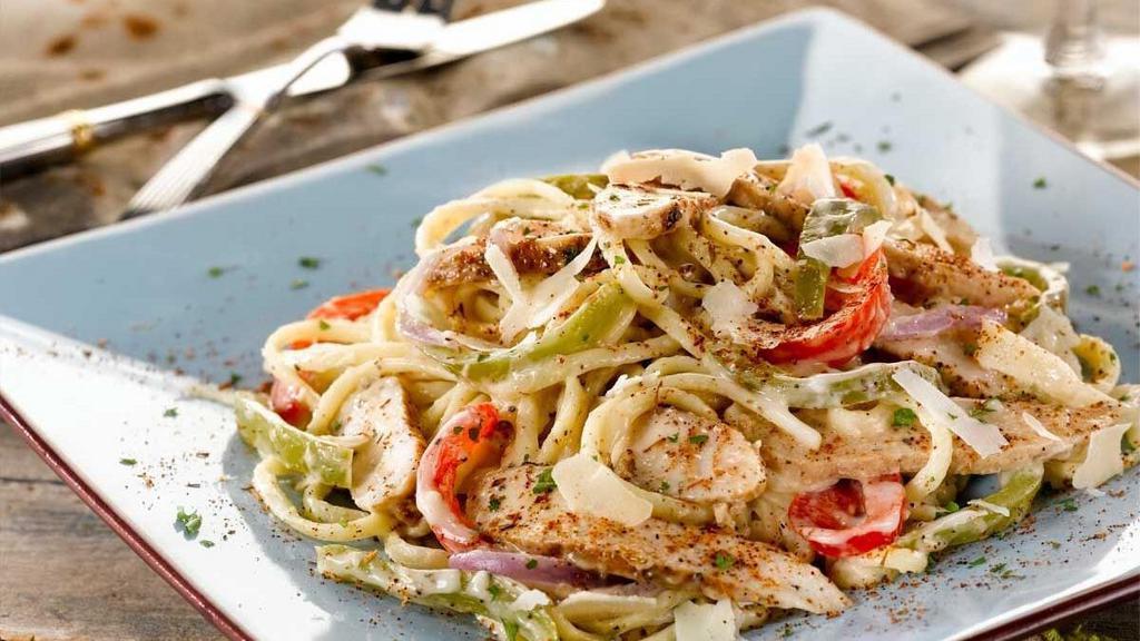 New Orleans Cajun Chicken Pasta · Grilled and sliced seasoned chicken with sauteed peppers, onions and parmesan cheese tossed with linguini in a cream sauce.