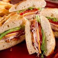 The Club Sandwich · Turkey, bacon, ham, cheddar and Monterey Jack cheeses with lettuce, tomato and mayo. Served ...