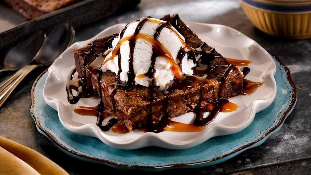 Brownie Lover'S Sundae For Two · Our decadent walnut brownie filled with toffee morsels, drizzled with chocolate and caramel sauces, topped with vanilla ice cream.
