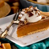 Ooey Gooey Caramel Pie - Slice · Creamy caramel in a graham cracker crust topped with whipped cream, chocolate morsels and pe...
