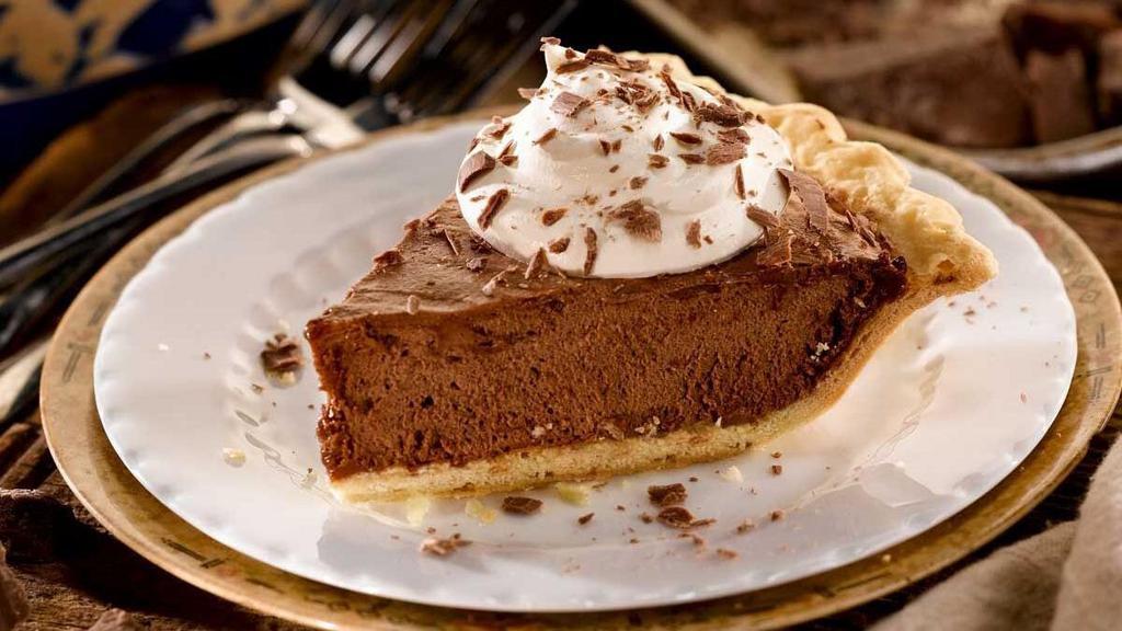 French Silk Pie - Slice · Semi-sweet chocolate blended into a velvety, smooth filling. Topped with whipped cream and chocolate morsels.