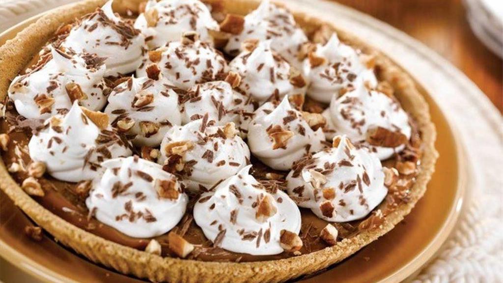 Whole Ooey Gooey Caramel Pie · Creamy caramel in a graham cracker crust topped with whipped cream, chocolate morsels and pecans.