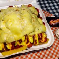 Salchipapas · Fried paps, sausages, bacon, melted cheese, corn, sauces.