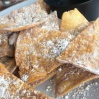 Sopapillas · Crispy fried puffy flour tortilla chips rolled in cinnamon and powdered sugar. Served with b...