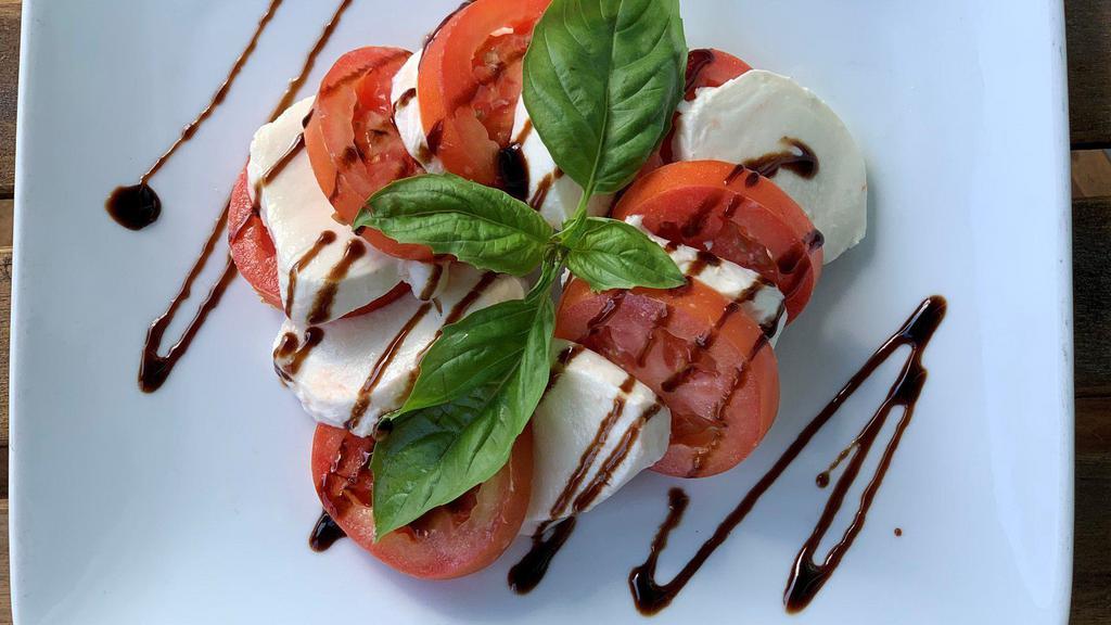 Caprese Mozzarella · Mozzarella fior di latte and sliced tomatoes topped with a balsamic glaze and fresh basil.