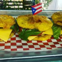 Chicken Jibartio  3 · Shredded Chicken on a fried plantain topped with cheese lettuce tomato and Garlic Aioli Sauc...