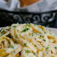 Fettuccine Alfredo · Russo's family favorite. Freshly prepared fettuccine pasta swirled in Russo’s homemade pecor...