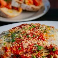 Chicken Parmesan · Tender chicken breast seasoned with Italian bread crumbs, topped with Russo's homemade marin...
