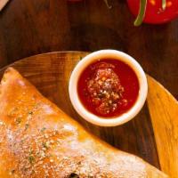 Create-Your-Own Calzone · Up to three toppings of your choice. We’ll add the mozzarella.
