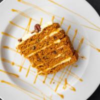 Carrot Cake · Layers of moist carrot cake studded with walnuts and cream cheese icing.