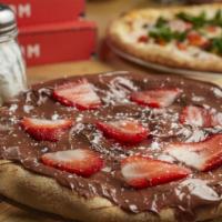 Chocolate Pizza · Small pizza with Nutella spread, strawberries and powdered sugar.