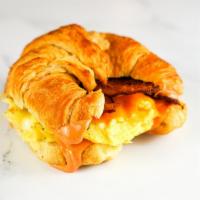 Bacon, Egg And Cheddar Croissant · 2 scrambled eggs, melted Cheddar cheese, smoked bacon, and Sriracha aioli on a  warm croissant