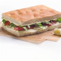 Mozzarella Focaccia · Focaccia mozzarella. Freshly toasted mozzarella-cheese focaccia bread, sun-dried tomato, aru...