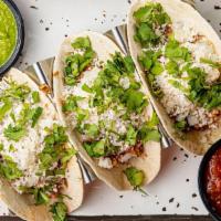 Chicken Tinga Tacos (3) · White onions, queso fresco and cilantro served in warm flour tortillas. Garnished with salsa...