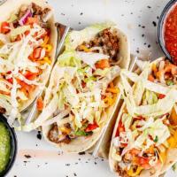Beef Tacos (3) · Queso dip, cheese, shredded lettuce and pico de gallo served in warm flour tortillas. Garnis...