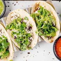 Grilled Steak Tacos · Queso fresca, charred onions, salsa verde and fresh cilantro