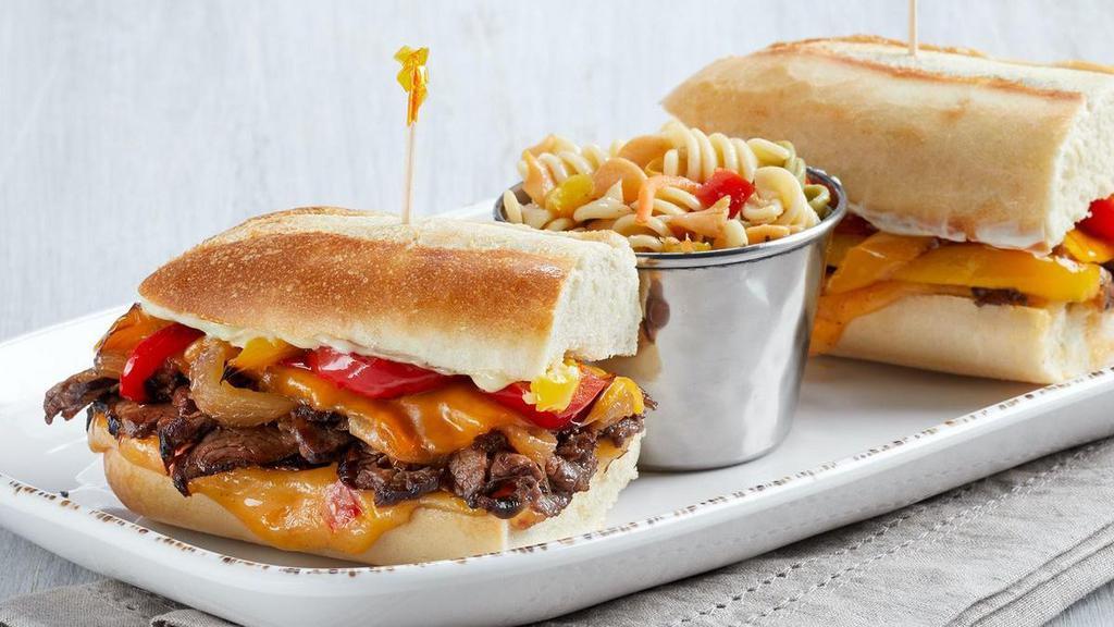 Newk'S Cheesesteak (P) · Medium-rare petite tenderloin steak, caramelized onions, red and yellow bell peppers, cheddar, our pimiento cheese, mayo on Parisian bread. (N)