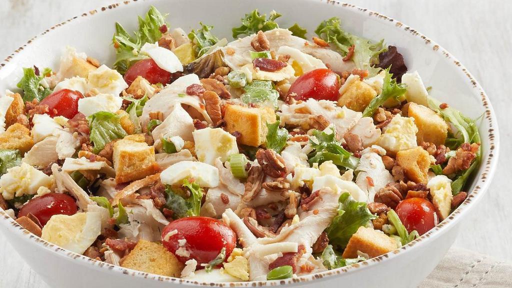 Cobb (P) · All-natural chicken, bacon, mixed greens, diced eggs,. Gorgonzola, grape tomatoes, green onions, pecans, croutons. with Bleu cheese dressing. Adds 380 cal
