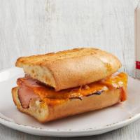Kid'S Toasted Ham & Cheese · Ham and aged cheddar cheese served warm on French Parisian bread with choice of fruit (45 ca...