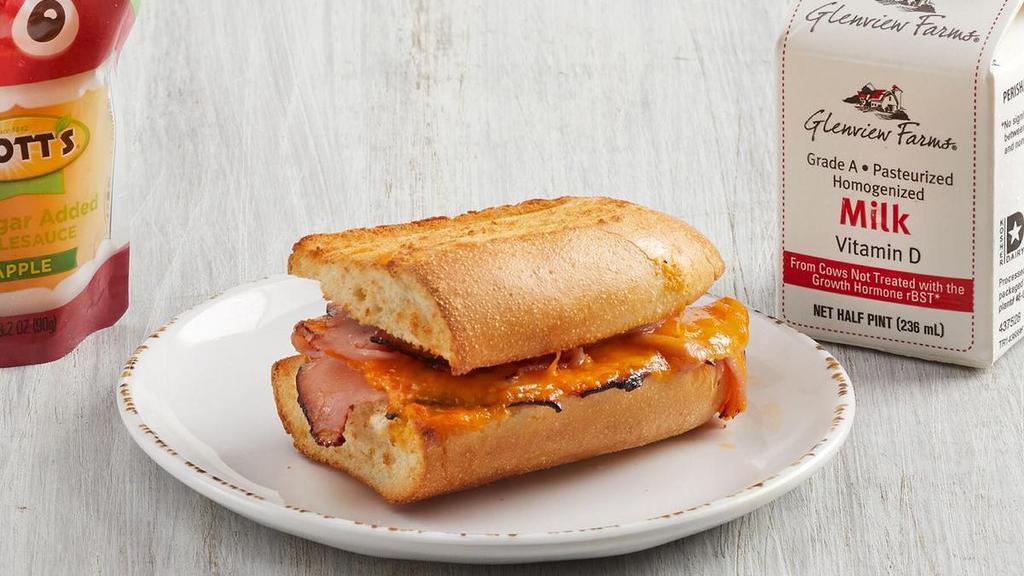 Kid'S Toasted Ham & Cheese · Ham and aged cheddar cheese served warm on French Parisian bread with choice of fruit (45 cal), applesauce (40 cal) or bag of chips (140-300 cal). For kids 12 and under. Includes kid’s fountain beverage (0-170 cal), apple juice (100 cal) or whole milk (150 cal).