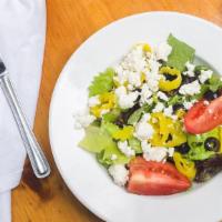 Greek Salad · Crisp romaine lettuce with mixed field greens, fresh tomatoes, black, and green olives, bana...