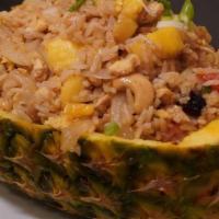 Pineapple Fried Rice · Chunks of pineapple with cashews, tomatoes, egg, raisins and onions; served in a pineapple.