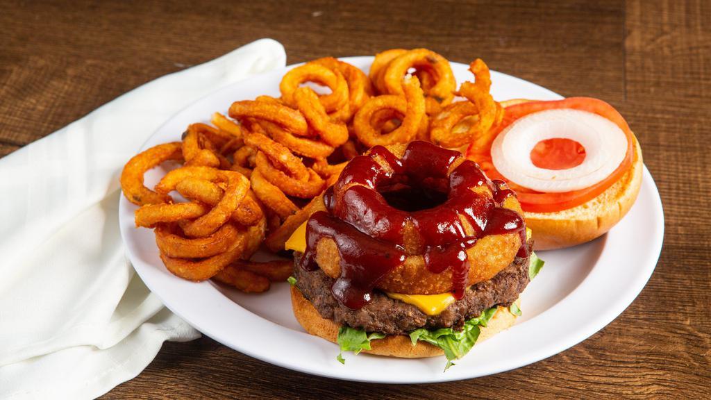 Cowboy Burger · Topped with American cheese, bbq sauce, and onion ring. Served with lettuce, tomato, onions, pickles, and fries.