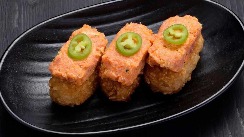Crispy Rice With Spicy Tuna · Crispy grilled sushi rice topped with spicy tuna. Garnished with sliced serrano pepper.