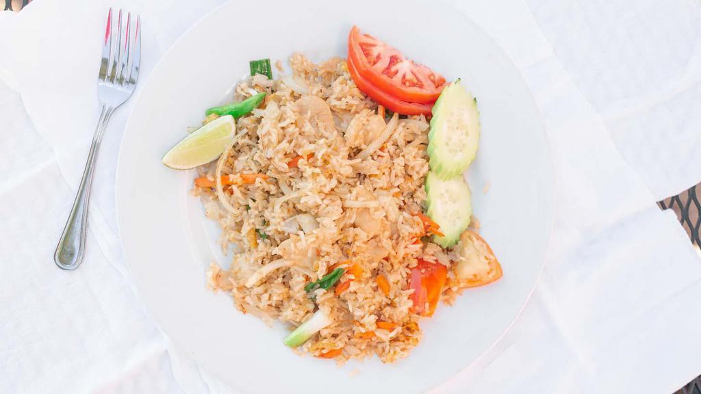 Thai Fried Rice · Stir-fried rice with tomatoes, onions, carrots and egg, in our homemade sauce.
