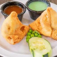Vegetable Samosa · Pyramid shaped pastry stuffed, potatoes, and spices.