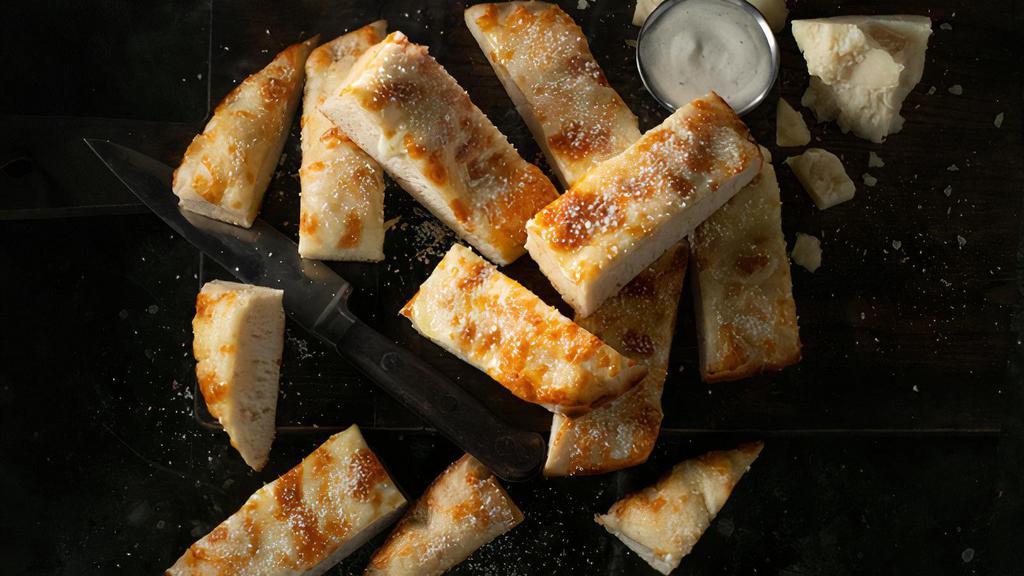 Jet'S Bread · 12 pcs. Freshly baked bread topped with premium mozzarella, topped with butter, garlic, and romano. Served with your choice of dipping sauce.