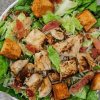 Caesar With Fire Roasted Chicken · romaine greens, bacon, shredded parmesan, fire roasted chicken, Caesar dressing & garlic cro...