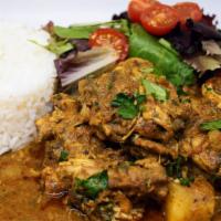 Curry Coconut Chicken · Indian-Caribbean fusion spiced chicken stewed to perfection in a coconut milk sauce and serv...