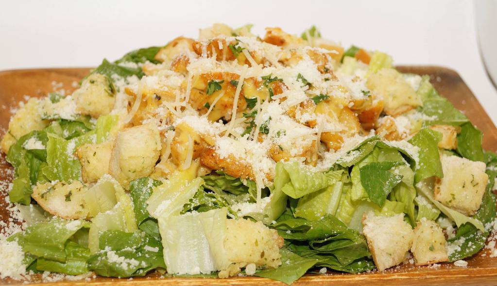 Chicken Caesar Salad · Grilled chicken served on a bed of romaine with grated Parmesan and Parmesan croutons.