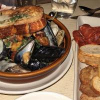 Sautéed Mussels And Clams · basil and pine nut pesto, calabrian chili, white wine butter sauce, garlic bread; may be pre...