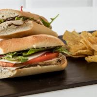 Roasted Chicken & Goat Cheese · Provolone cheese, oven roasted tomatoes, organic arugula, dijon balsamic vinaigrette and lem...