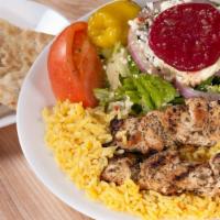 Light - Chicken Skewers (Souvlaki) · Two chicken skewers over rice with Greek salad.