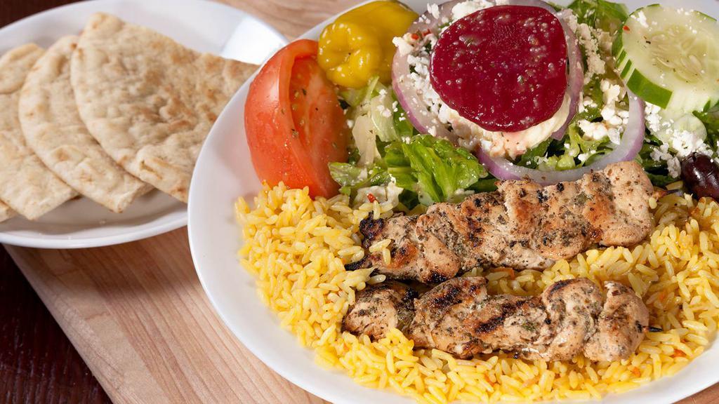 Chicken Skewers · Souvlaki. Two char-grilled chicken skewers over rice with a greek salad. 1017 cal.