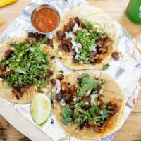 Authentic Mexican Tacos · Four mini corn or flour tortillas, served with your choice of meat, topped with onions, cila...