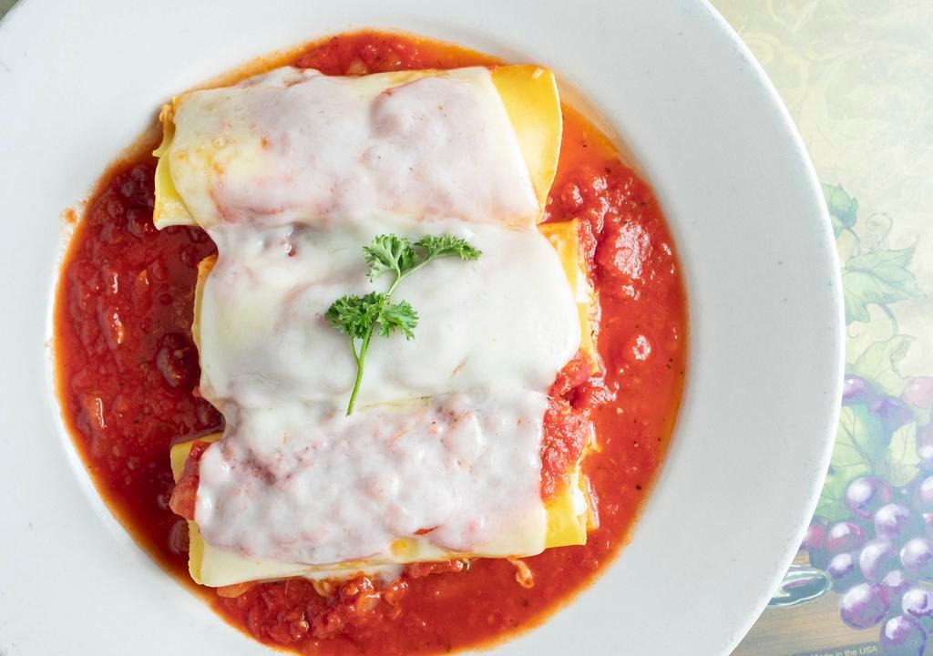 Manicotti Lunch · Hand rolled pasta tubes filled with ricotta cheese, covered with marinara and baked with melted mozzarella. Served with three garlic rolls.