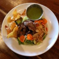 Thai Beef Salad · Grilled flank steak on top of crispy romaine lettuce, sauteed onions, tomatoes, cucumbers, c...