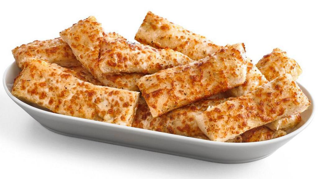Garlic Cheesy Bread · Crispy, yet tender breadsticks made with our Pan dough. Brushed with garlic butter and sprinkled with 100% real cheese and Parmesan oregano seasoning.  (16 Slices). *Calories listed are by slice