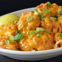 Voodoo Shrimp · Hand breaded popcorn shrimp, spicy remoulade sauce served on the side, green onion