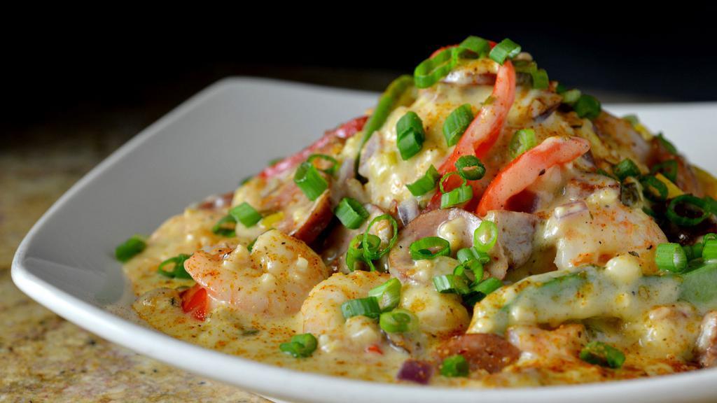 Shrimp And Grits · Shrimp, andouille sausage, peppers, onion, over cheese grits
