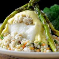 Chilean Sea Bass Oscar · Mesquite grilled, blue lump crab, asparagus, hollandaise, served on a bed of cous cous with ...