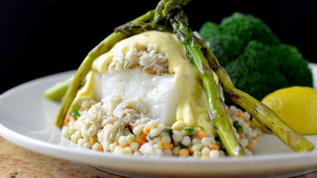 Chilean Sea Bass Oscar · Mesquite grilled, blue lump crab, asparagus, hollandaise, served on a bed of cous cous with choice of side